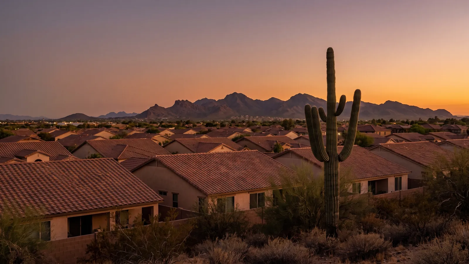 Tile rooftops in Surprise, Arizona at sunset with the White Tank Mountains on the horizon